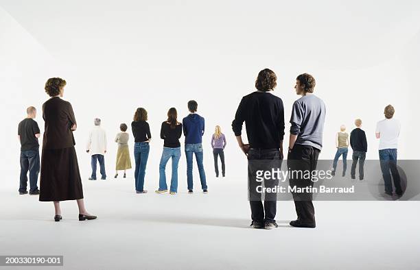 group of people standing in studio, rear view - ganzkörperansicht stock-fotos und bilder