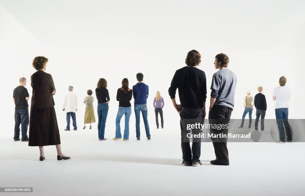 Group of people standing in studio, rear view