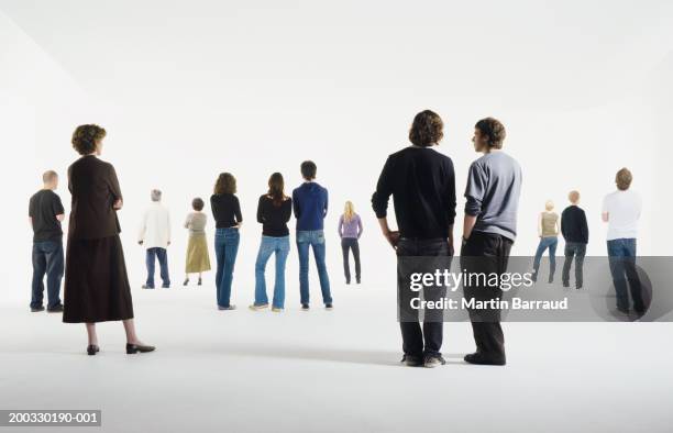 group of people standing in studio, rear view - vue de dos photos et images de collection