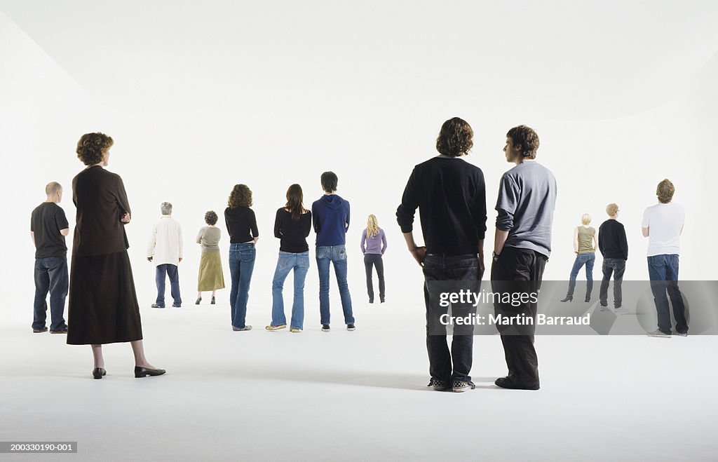 Group of people standing in studio, rear view