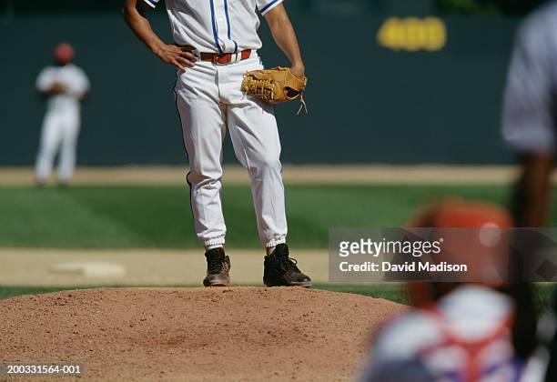 baseball pitcher on mound, catcher in foreground, low section - pro baseball pitcher stock pictures, royalty-free photos & images