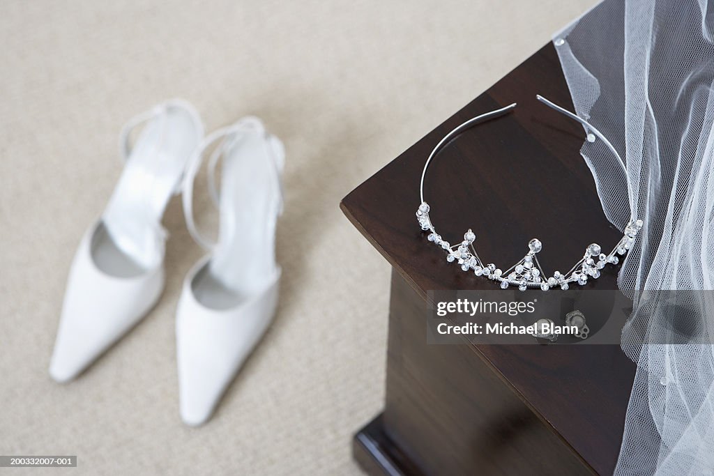 Tiara and earings on cabinet, shoes on floor (focus on foreground)