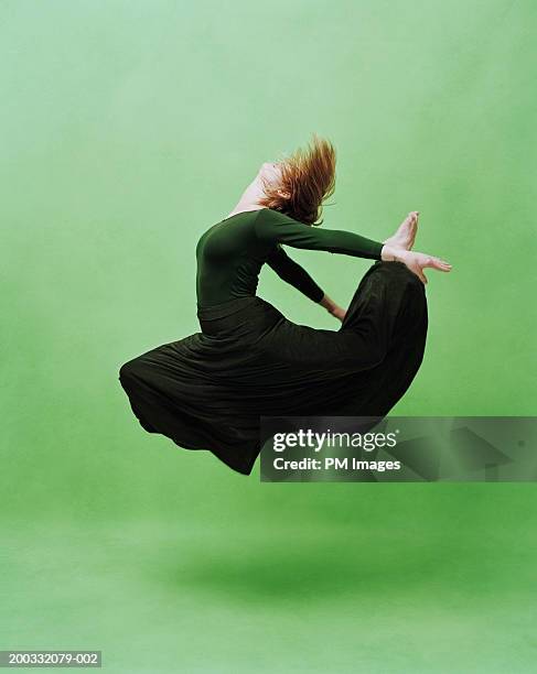 young female dancer leaping, side view - abstract dancing stock pictures, royalty-free photos & images