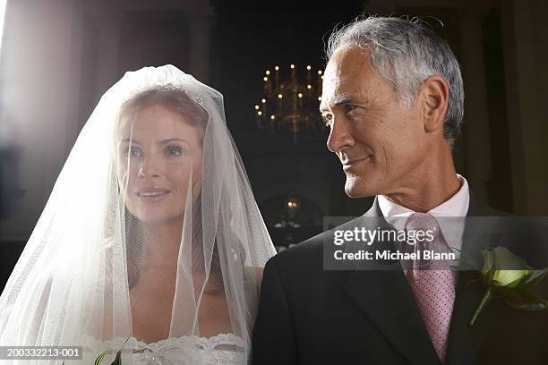 bride walking down aisle, arm linked with father's, smiling, close-up - old man young woman stockfoto's en -beelden
