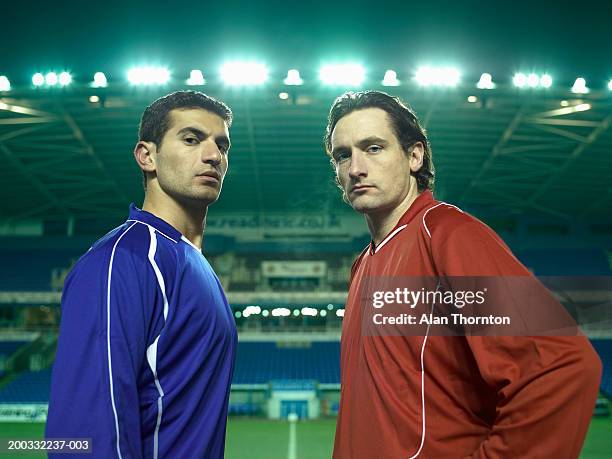 two male football players on pitch, portrait, night - football player standing stock pictures, royalty-free photos & images