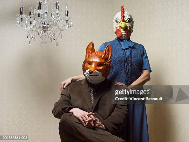 couple sitting wearing fox and chicken masks, portrait - animals and people imagens e fotografias de stock