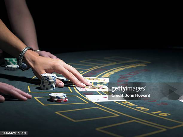 two women playing blackjack at gaming table, close-up - blackjack table stock pictures, royalty-free photos & images