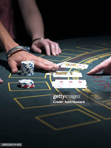 two women playing blackjack at gaming table, close-up - croupier foto e immagini stock