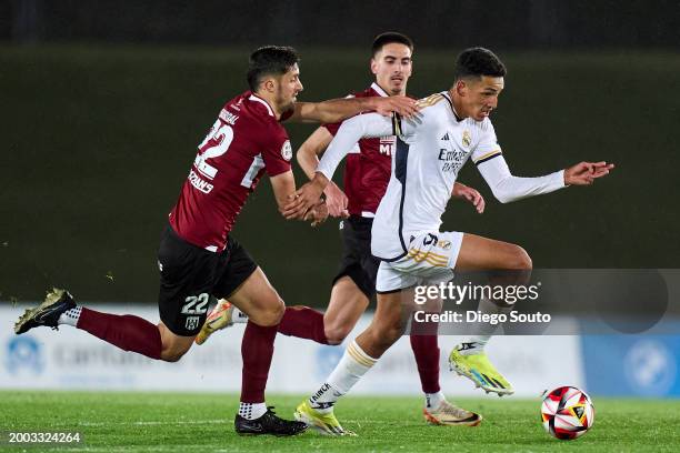 Alvaro Rodriguez of Real Madrid Castilla battle for the ball with Tomas Bourdal of Merida during Primera RFEF match between Real Madrid Castilla and...