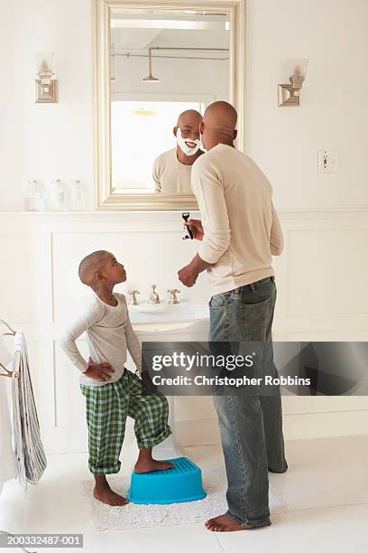 man shaving in bathroom watched by son (4-6) - barefoot black men stock pictures, royalty-free photos & images