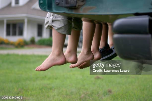 three children (3-7) sitting on tailgate, close-up of hanging feet - feet girl stock pictures, royalty-free photos & images