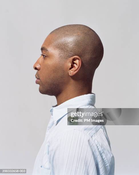 young man wearing earing, close-up, profile - shaved head profile stock pictures, royalty-free photos & images