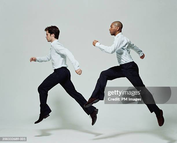 two businessmen running, side view - ワイシャツ ストックフォトと画像