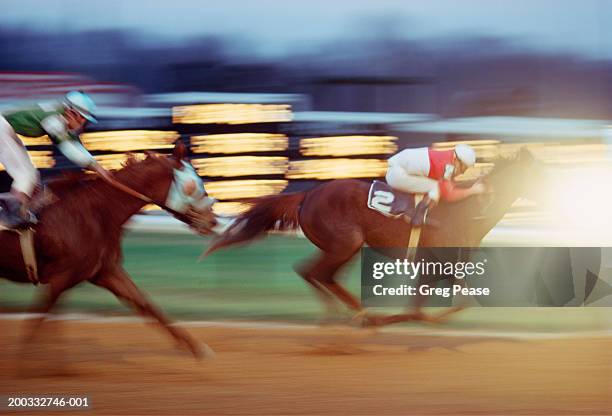 thoroughbred horses approaching finish line (blurred motion) - championship day two stock pictures, royalty-free photos & images