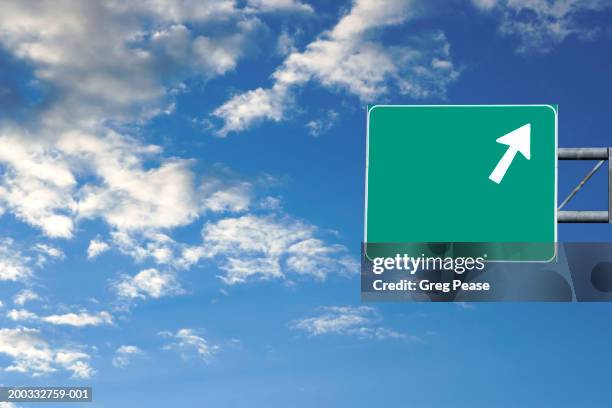 highway sign against blue sky with clouds (digital composite) - road sign foto e immagini stock