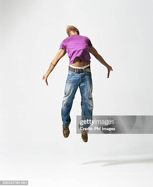 young man jumping, arching back - floating mid air stock pictures, royalty-free photos & images