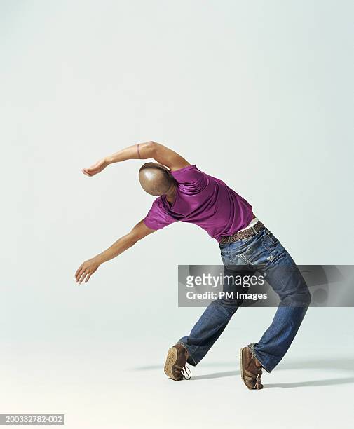 young man falling backwards, rear view - anlehnen stock-fotos und bilder