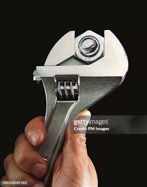 hand tightening nut and bolt with wrench - adjustable wrench stockfoto's en -beelden