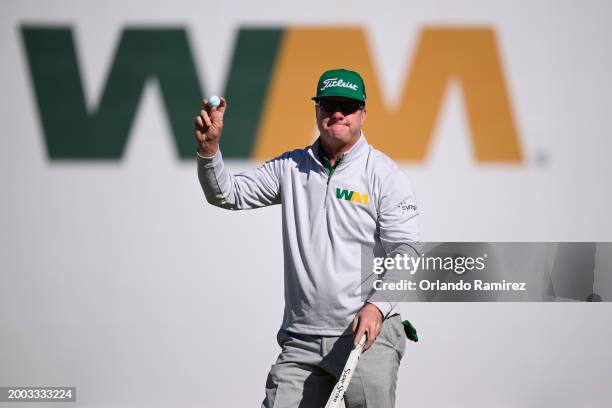 Charley Hoffman of the United States reacts after putting on the 16th green during the continuation of the third round of the WM Phoenix Open at TPC...