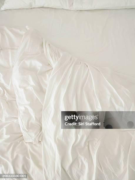unmade bed with white sheets - sheets stock pictures, royalty-free photos & images