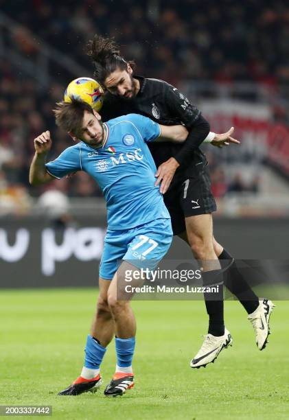 Khvicha Kvaratskhelia of SSC Napoli and Yacine Adli of AC Milan battle for a header during the Serie A TIM match between AC Milan and SSC Napoli at...
