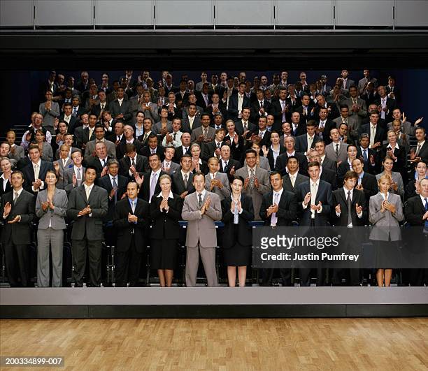 people giving standing ovation in auditorium (digital composite) - businessman applauding stock pictures, royalty-free photos & images
