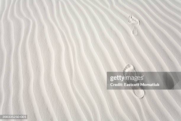 footprints of barefoot hiker on white gypsum sand dune - white sand stock pictures, royalty-free photos & images