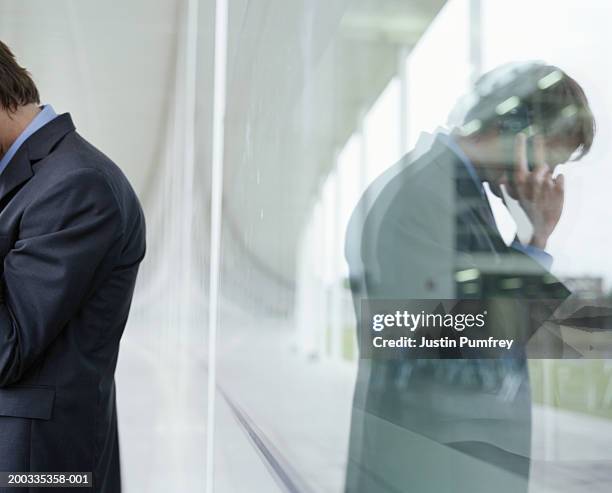 Using Phone Ref Perspective Businessman Using Mobile Phone Reflection In Glass Side View High-Res ...