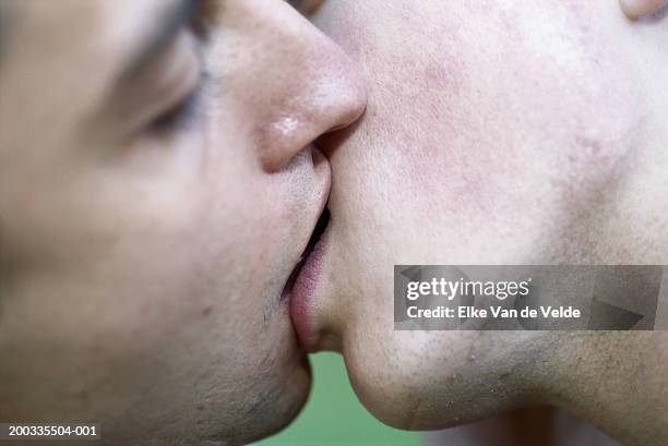 two young men kissing, side view, close-up - extreme close up kiss stock pictures, royalty-free photos & images