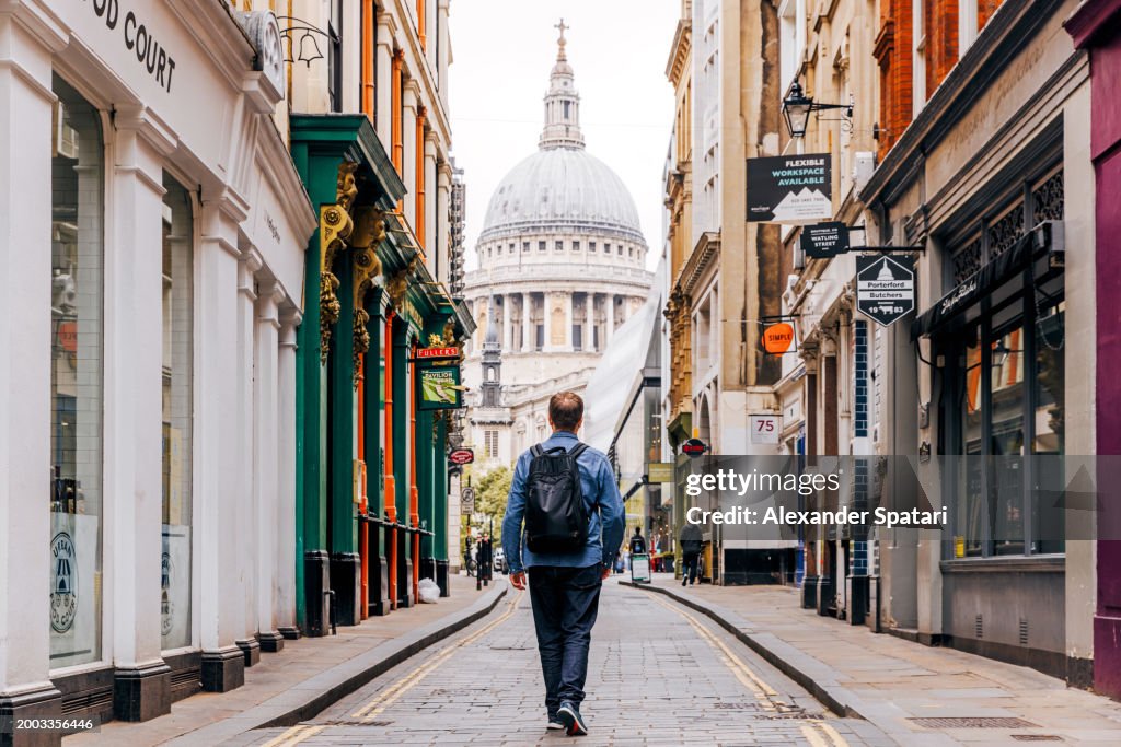 Tourist exploring streets of London with St. Paul's Cathedral in the center, London, UK