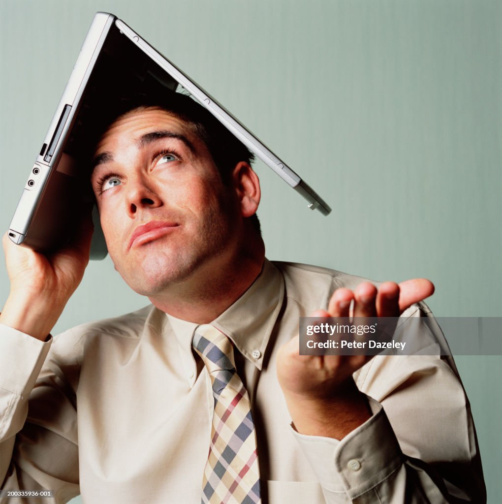 Man Looking Up Laptop Computer On Head High-Res Stock Photo - Getty Images
