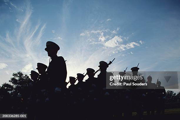 silhouetted naval cadets marching in formation, low angle view - onderwijsinstituten en organisaties stockfoto's en -beelden