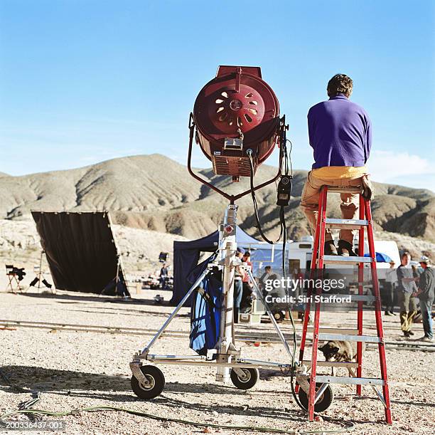 film crew in desert, spotlight in foreground - tv crew stock pictures, royalty-free photos & images
