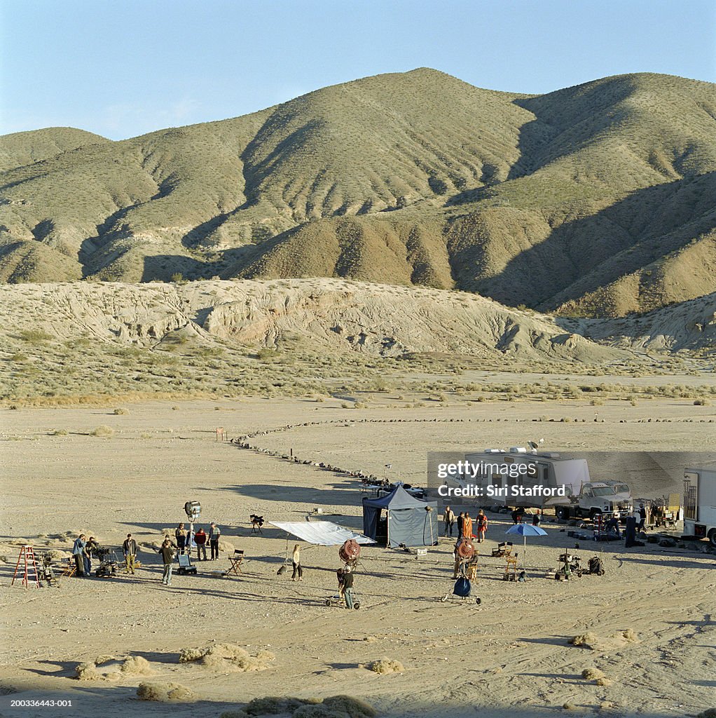 Film crew on location in desert, elevated view