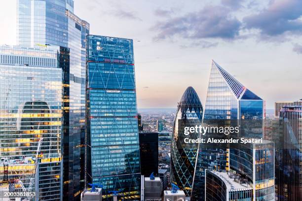 illuminated skyscrapers in city of london financial district at dusk, aerial view, london, uk - city buildings stock pictures, royalty-free photos & images