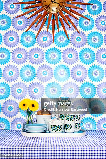 tea set, flowers and biscuits on tray beneath sun clock - kitsch fotografías e imágenes de stock