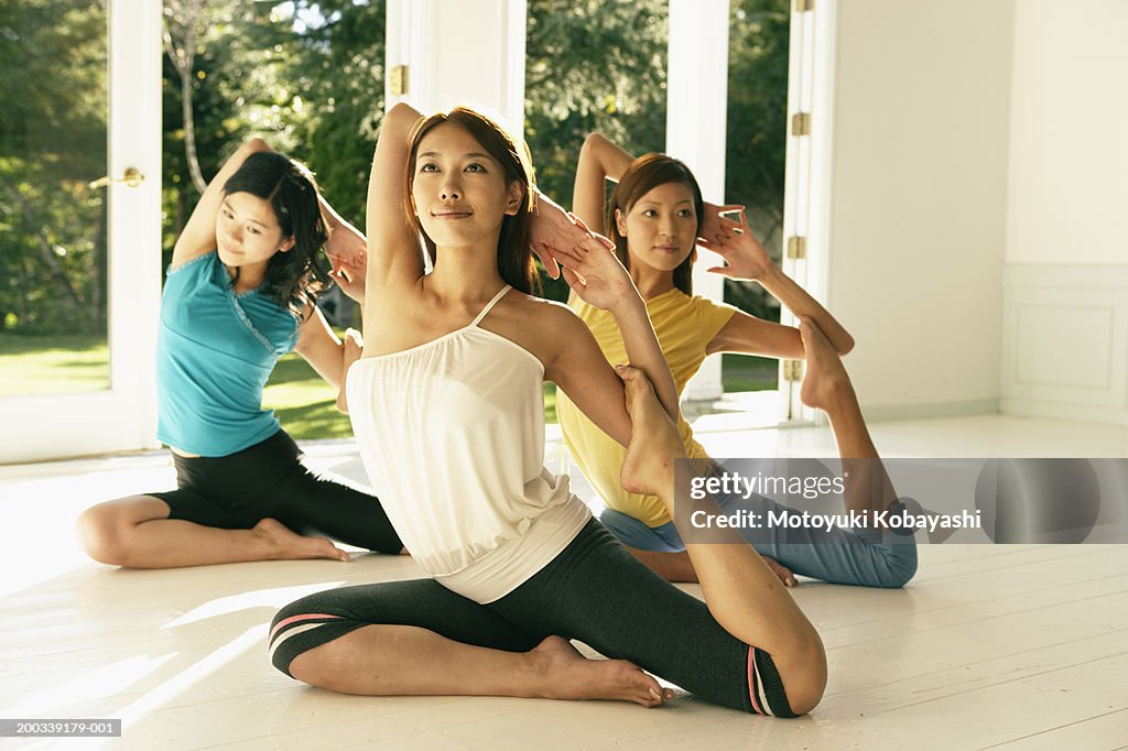 Three young women in pigeon pose