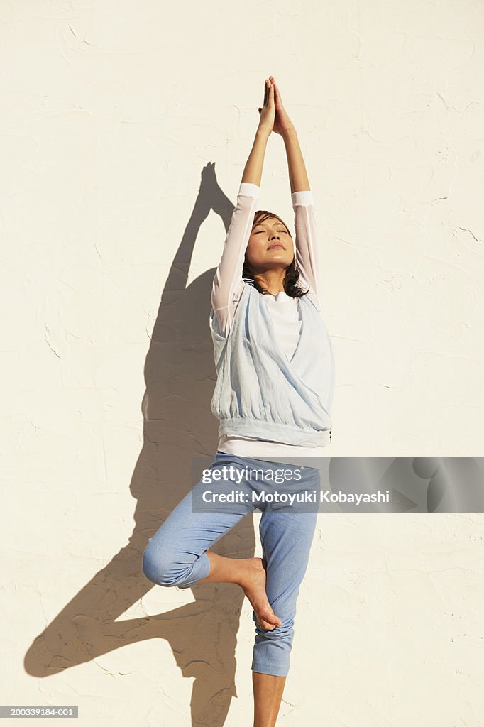 Young woman in tree pose