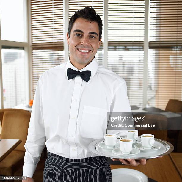 waiter holding tray with four cups of coffee, portrait, close-up - 蝶ネクタイ ストックフォトと画像