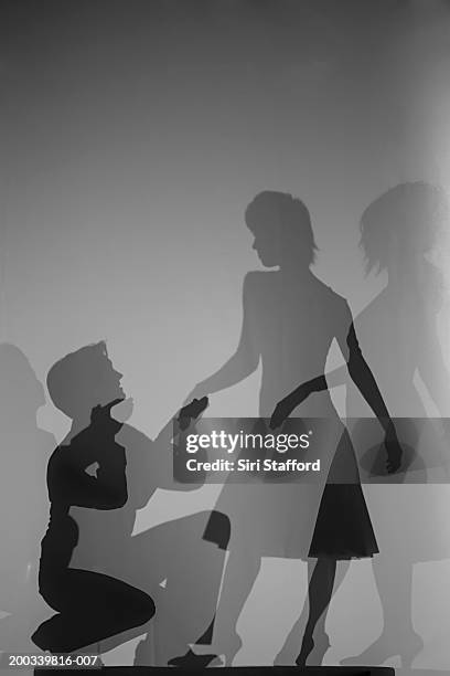 silhouette of man proposing to woman - black and white lovers stock pictures, royalty-free photos & images