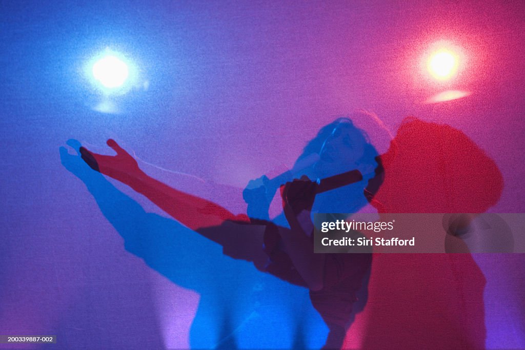 Young man singing, casting shadows