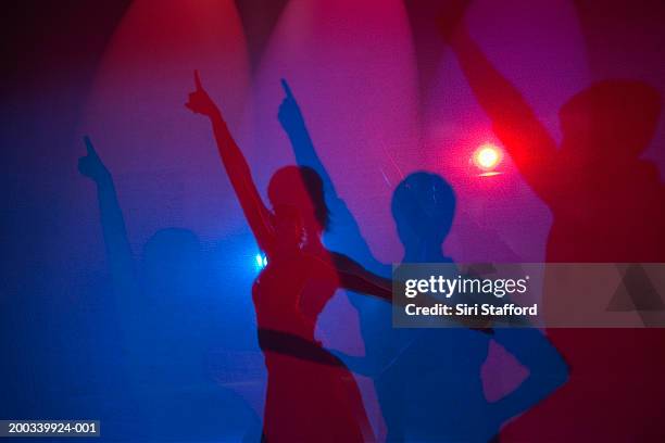 shadows of couple dancing - disco dancing stock pictures, royalty-free photos & images