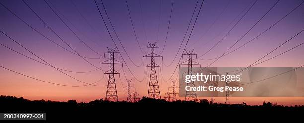 transmission towers, dusk (digital composite) - energieerzeugung stock-fotos und bilder