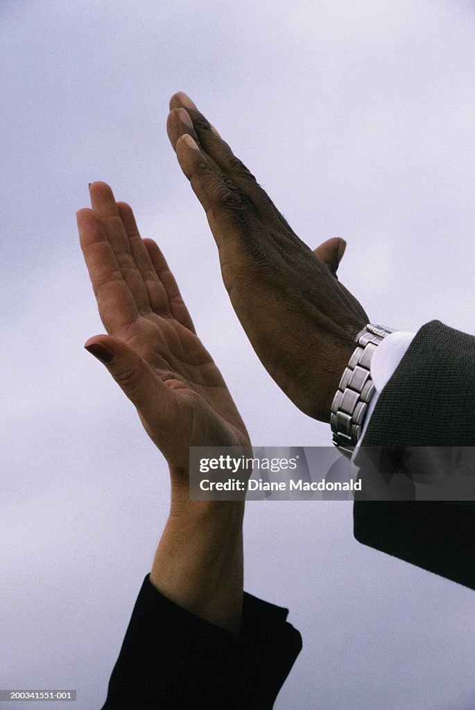 Man and woman slapping palms, close-up