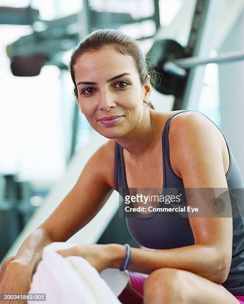 woman sitting on exercise machine in gym, sweating, portrait, close-up - gym resting stock pictures, royalty-free photos & images