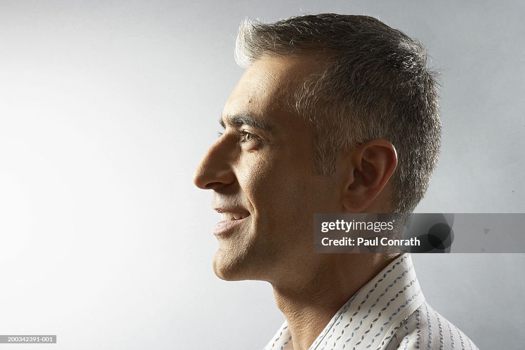 Man smiling, side view