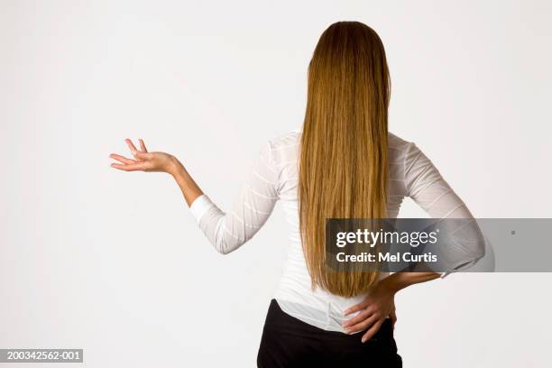 woman shrugging, one hand on hip, rear view - blouse back stock pictures, royalty-free photos & images