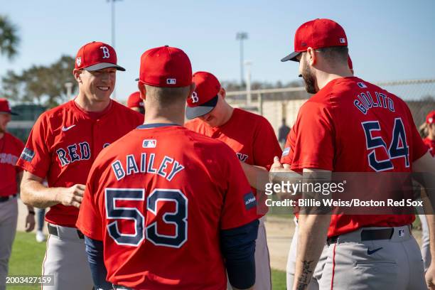 Nick Pivetta and Lucas Giolito of the Boston Red Sox talk with pitching coach Andrew Bailey during a spring training team workout on February 14,...