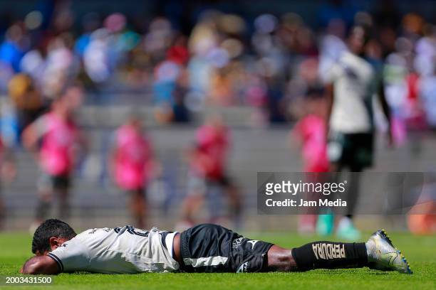 Brayan Angulo of Puebla lies on the pitch during the 6th round match between Pumas UNAM and Puebla as part of the Torneo Clausura 2024 Liga MX at...