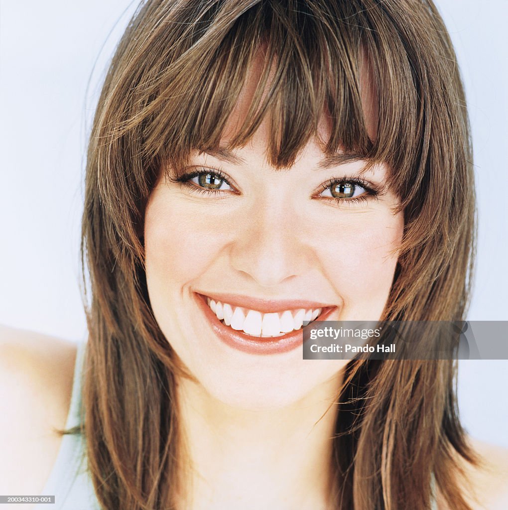 Young woman smiling, portrait, close-up